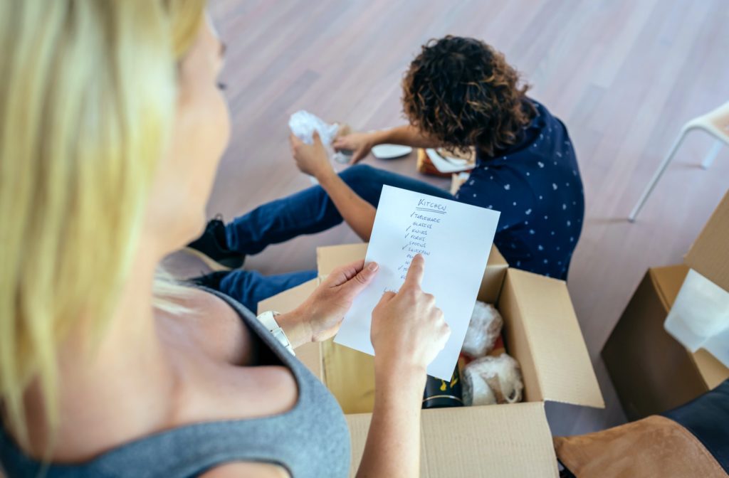 Couple unpacking moving boxes